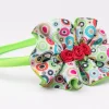 Colourful ruffle flower headband with red rosette centre