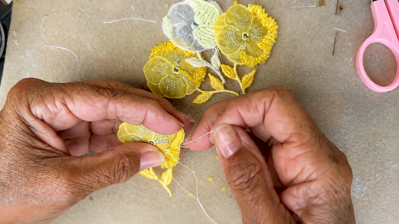 Handmade embroidered headband featuring delicate yellow floral embroidery, beads, and hand-stitched details.