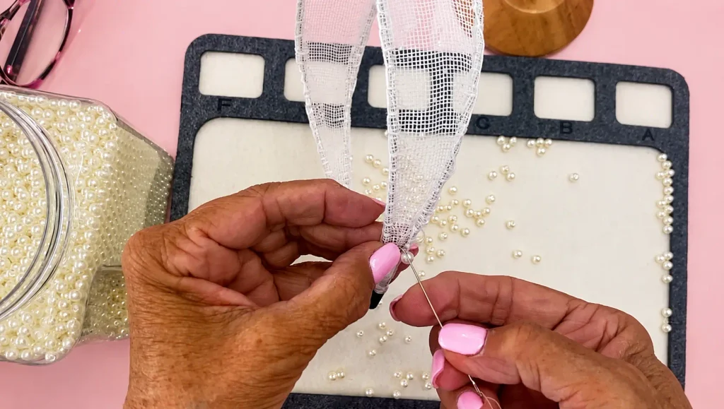 Close-up of hands handmaking a pearl-embellished handmade headband with white mesh ribbon and pearl beads, Grace's Designs Canada, handmade headbands Canada